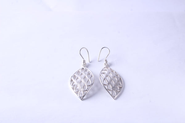 Pair of handcrafted sterling silver leaf earrings with an openwork design on a white background
