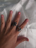 Two handcrafted 925 sterling silver dragon rings worn on a hand to show scale and detail.
