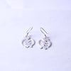 Pair of handcrafted sterling silver symbol dangle earrings on a clean white background
