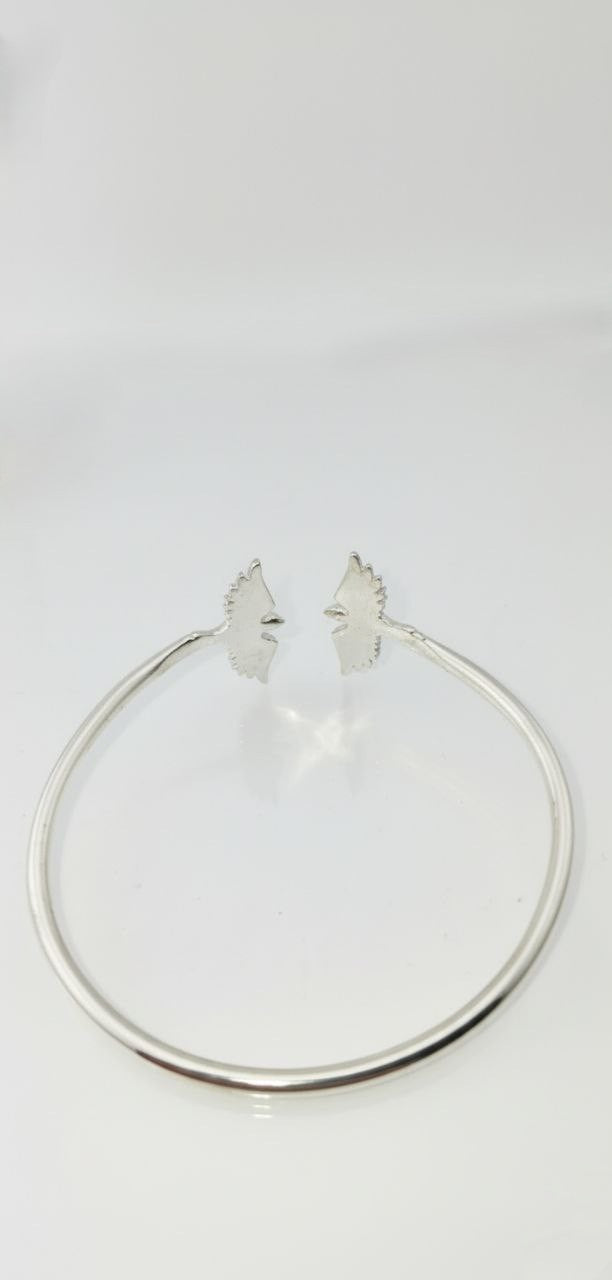 “back view of 925 sterling silver bird-wing cuff bracelet on white background”