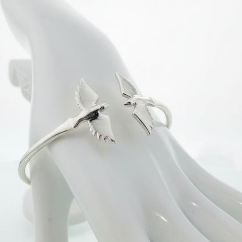 925 sterling silver cuff bracelet with twin bird wings design displayed on hand model