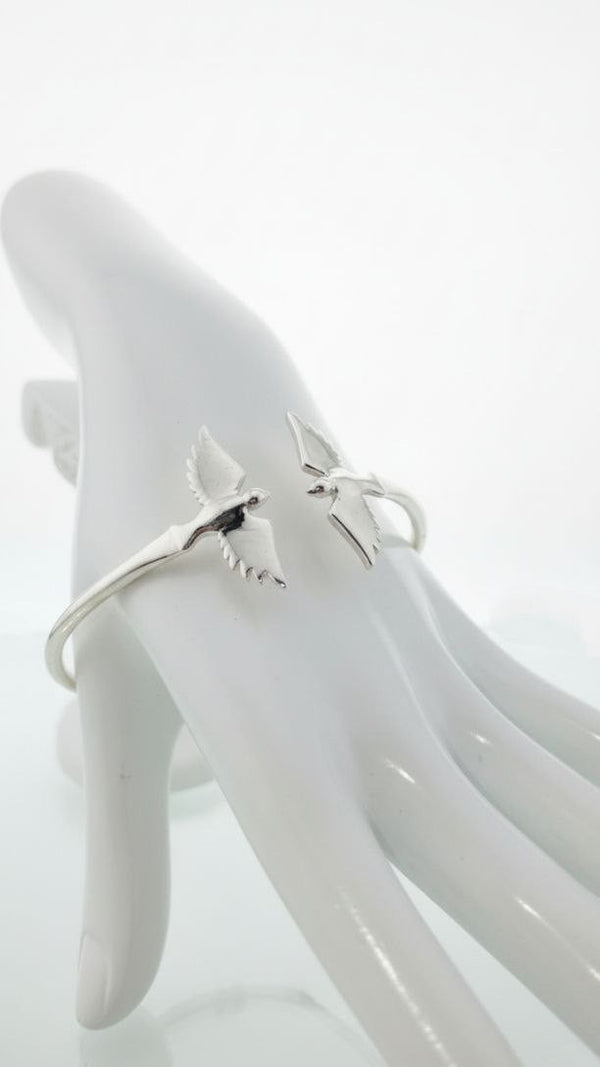 925 sterling silver cuff bracelet with twin bird wings design displayed on hand model