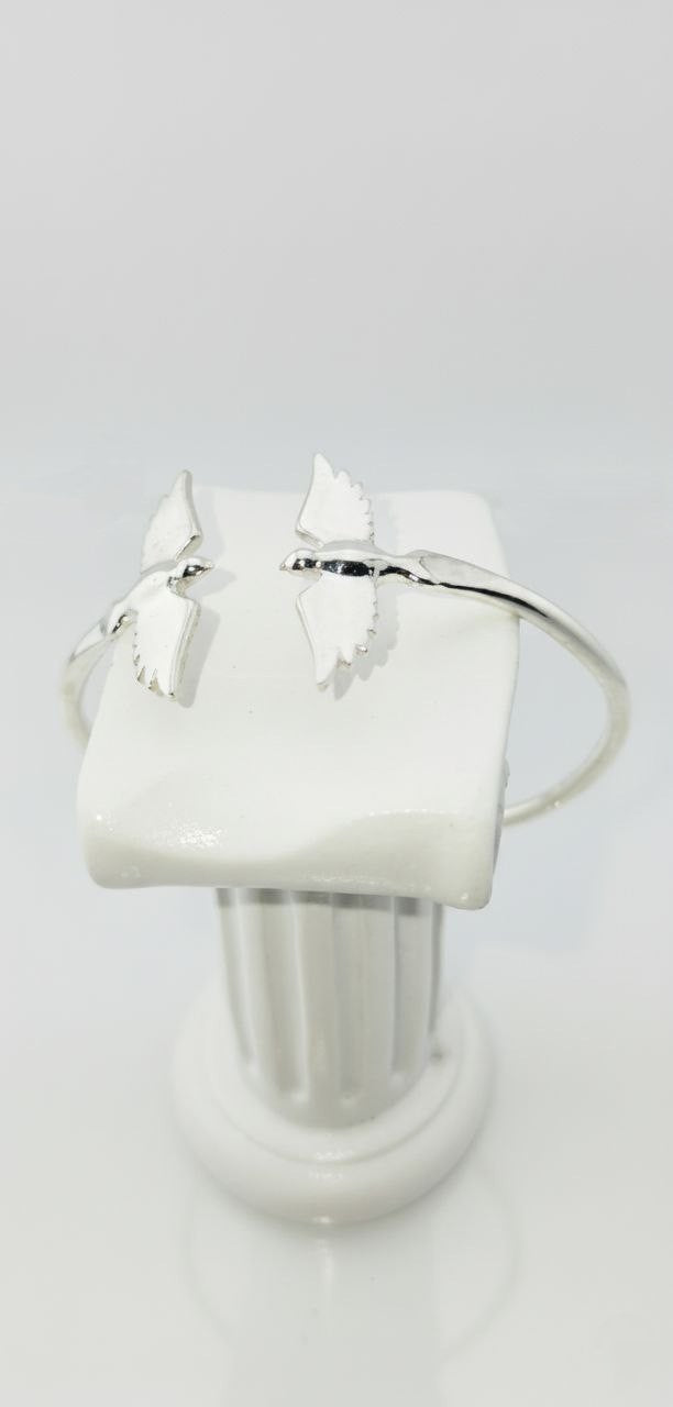 "925 sterling silver twin wings of freedom cuff bracelet displayed on white jewelry stand"