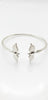top view of 925 sterling silver cuff bracelet with twin bird-wing design on white background