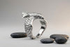 Detailed ring made of 925 sterling silver in the shape of a raven, unisex design. Wrapping wings create a textured band. Minimalist style, handmade.